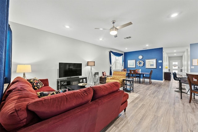 living room featuring light wood finished floors, ceiling fan, recessed lighting, and baseboards