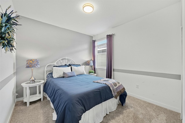 bedroom featuring carpet floors and baseboards