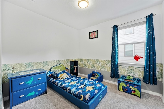 bedroom featuring carpet and baseboards