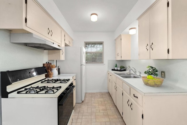 4613 Greenridge Ter, Austin, TX 78745 - kitchen with white range with gas stovetop, under cabinet range hood, a sink, light countertops, and baseboards