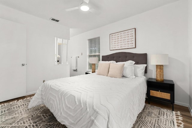 bedroom featuring wood finished floors, baseboards, and ceiling fan