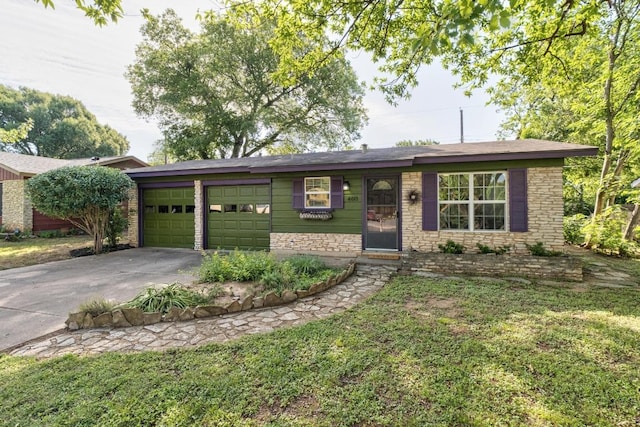 ranch-style house featuring concrete driveway, an attached garage, stone siding, and a front yard