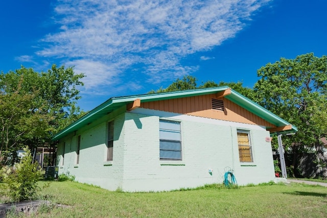 1305 Larkspur Rd, Austin, TX 78758 - view of property exterior featuring a lawn and brick siding