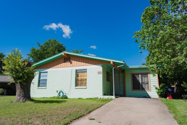 1305 Larkspur Rd, Austin, TX 78758 - view of front of house featuring a front lawn and brick siding
