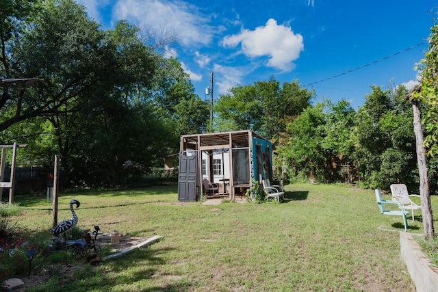 1305 Larkspur Rd, Austin, TX 78758 - view of green lawn featuring an outdoor structure and view of wooded area