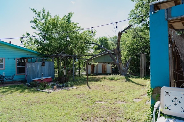 1305 Larkspur Rd, Austin, TX 78758 - view of grassy yard featuring an outdoor structure and a storage unit