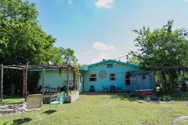 1305 Larkspur Rd, Austin, TX 78758 - back of house featuring a lawn and a patio