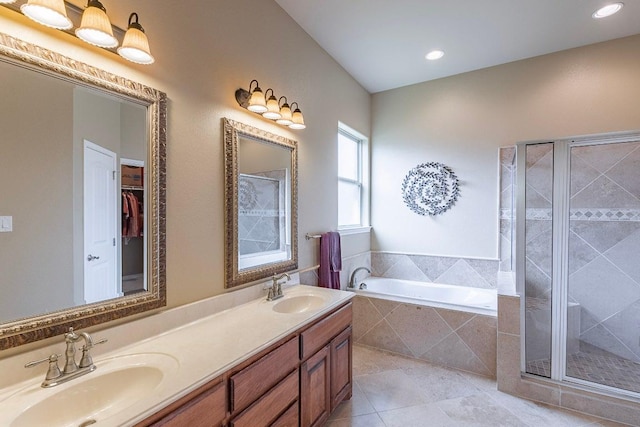 full bath with a shower stall, tile patterned flooring, a garden tub, double vanity, and recessed lighting