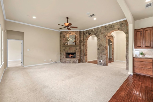 15105 General Williamson Dr, Austin, TX 78734 - unfurnished living room featuring arched walkways, a ceiling fan, dark wood-style floors, recessed lighting, and a large fireplace