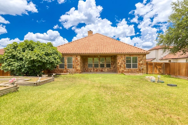 15105 General Williamson Dr, Austin, TX 78734 - back of house with stone siding, a fenced backyard, a chimney, and a tile roof