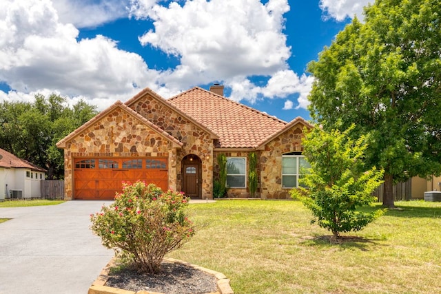 15105 General Williamson Dr, Austin, TX 78734 - view of front of house featuring a chimney, stone siding, a tile roof, an attached garage, and driveway