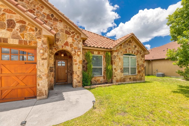 15105 General Williamson Dr, Austin, TX 78734 - entrance to property featuring stone siding, a lawn, and a tile roof