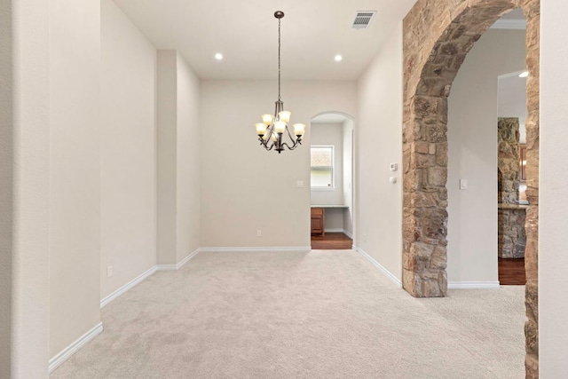 15105 General Williamson Dr, Austin, TX 78734 - unfurnished room with arched walkways, light carpet, a chandelier, and recessed lighting