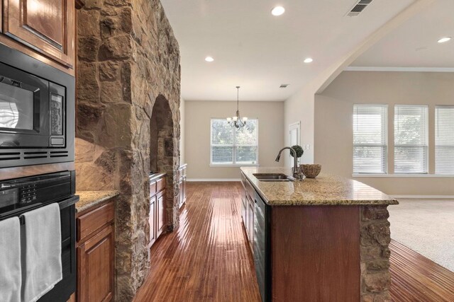 15105 General Williamson Dr, Austin, TX 78734 - kitchen with black appliances, light stone countertops, recessed lighting, a kitchen island with sink, and dark wood finished floors