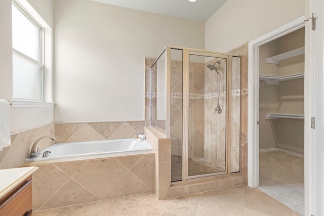 15105 General Williamson Dr, Austin, TX 78734 - bathroom featuring a garden tub, a shower stall, a walk in closet, vanity, and tile patterned flooring