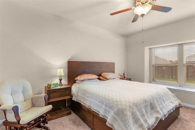 bedroom featuring light colored carpet, baseboards, and ceiling fan