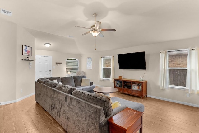 living room featuring light wood-style flooring, ceiling fan, baseboards, and lofted ceiling