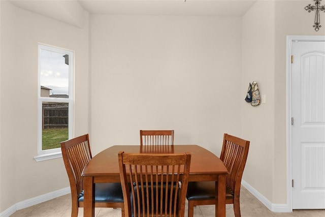 dining space featuring baseboards and light tile patterned floors