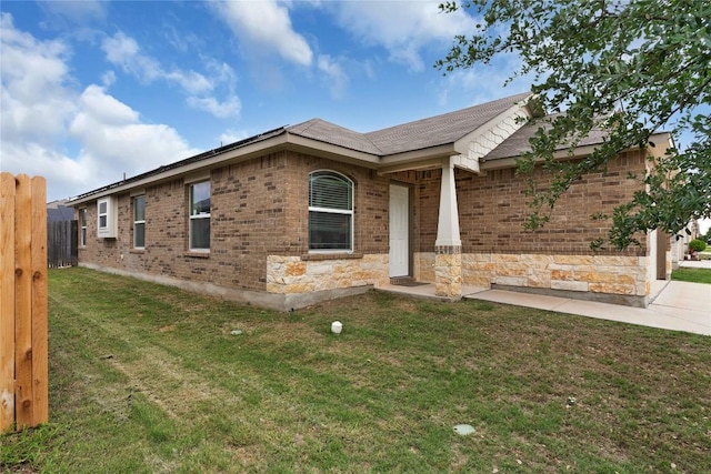 view of front of house featuring brick siding and a shingled roof