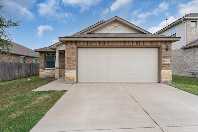 single story home featuring driveway, an attached garage, and brick siding