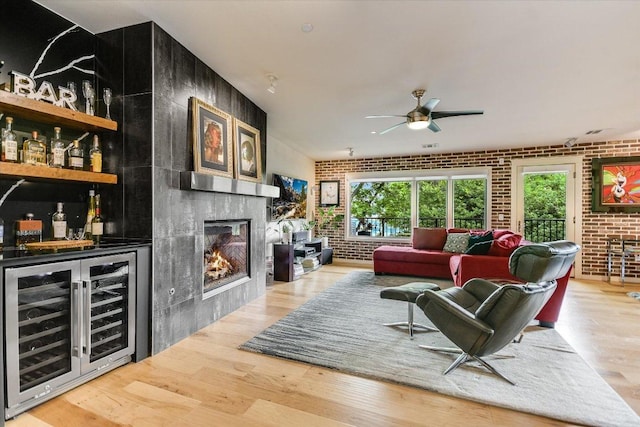 3200 Grandview St Unit 15, Austin, TX 78705 - living room with wine cooler, brick wall, a dry bar, wood finished floors, and a glass covered fireplace