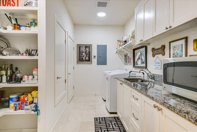 3200 Grandview St Unit 15, Austin, TX 78705 - laundry area with electric panel, washing machine and clothes dryer, baseboards, and light tile patterned flooring