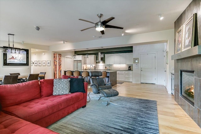 3200 Grandview St Unit 15, Austin, TX 78705 - living area with light wood finished floors, a ceiling fan, and a large fireplace