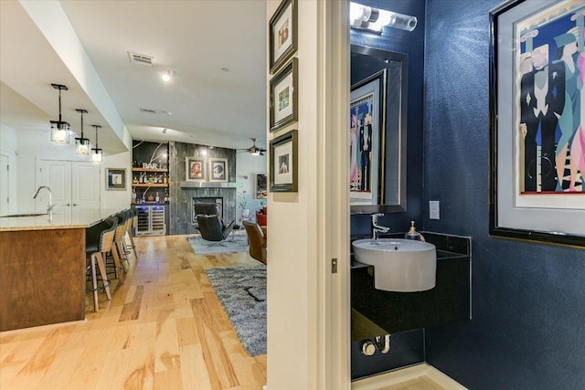 3200 Grandview St Unit 15, Austin, TX 78705 - bathroom featuring wood finished floors, a fireplace, a sink, and a ceiling fan