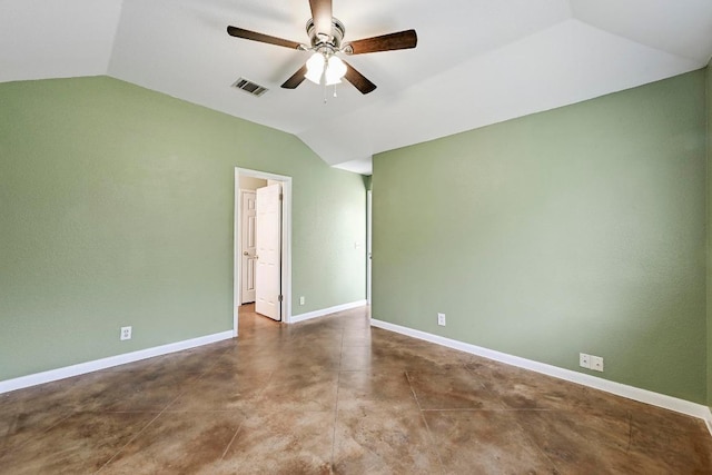 spare room with vaulted ceiling, a ceiling fan, baseboards, and concrete floors