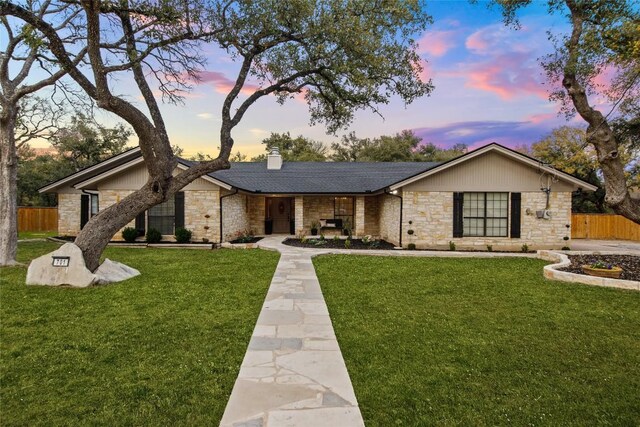 701 W Esparada Dr, Georgetown, TX 78628 - view of front of property featuring stone siding, a chimney, and a shingled roof