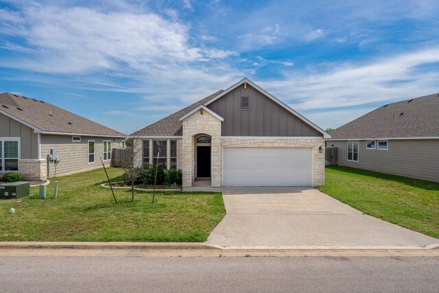 7317 Buffalo Grass Dr, Temple, TX 76502 - view of front of property featuring stone siding, board and batten siding, a front yard, and a garage