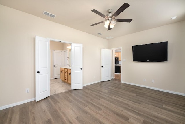 7317 Buffalo Grass Dr, Temple, TX 76502 - unfurnished bedroom with wood finished floors, baseboards, and connected bathroom