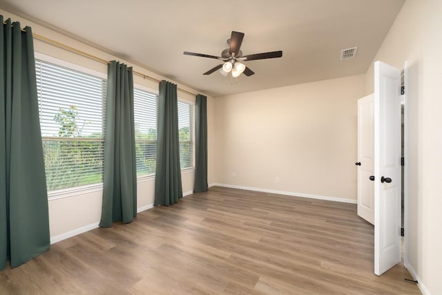7317 Buffalo Grass Dr, Temple, TX 76502 - unfurnished room with light wood-style floors, a ceiling fan, and baseboards