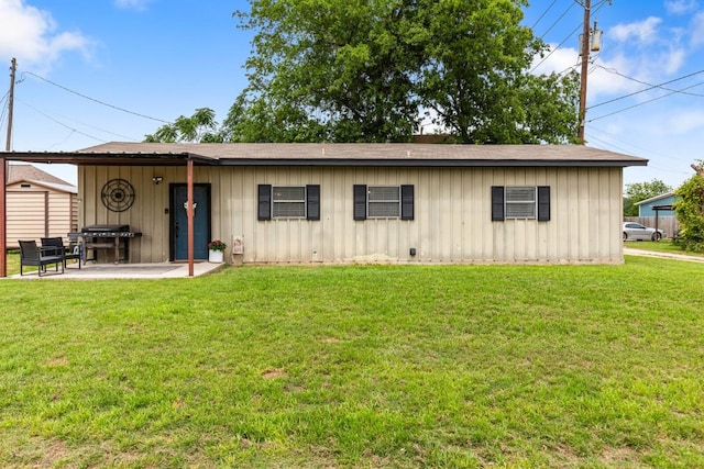 131 Norm St, China Spring, TX 76633 - view of front of house with board and batten siding, a front lawn, and a patio area