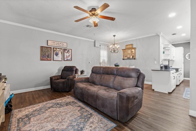 131 Norm St, China Spring, TX 76633 - living room featuring ceiling fan, crown molding, dark wood-style flooring, baseboards, and a chandelier
