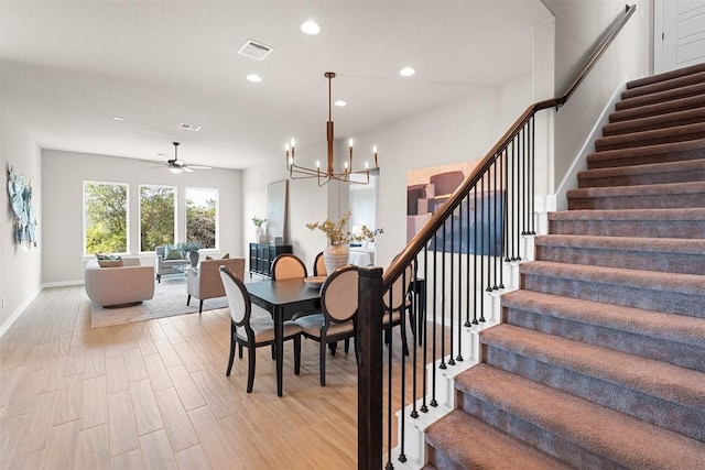 324 Pisa Ln, Georgetown, TX 78628 - dining space with stairs, recessed lighting, a chandelier, light wood-type flooring, and baseboards
