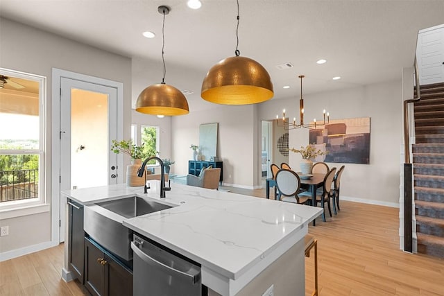 324 Pisa Ln, Georgetown, TX 78628 - kitchen with stainless steel dishwasher, a sink, baseboards, a chandelier, and recessed lighting