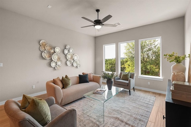 324 Pisa Ln, Georgetown, TX 78628 - living area with a ceiling fan, baseboards, and light wood-style flooring