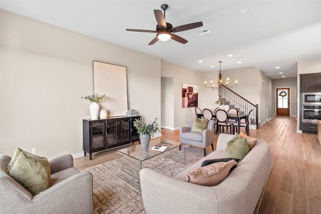 324 Pisa Ln, Georgetown, TX 78628 - living room with a chandelier, baseboards, ceiling fan, light wood-style floors, and recessed lighting