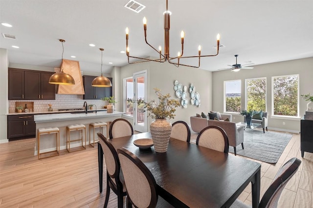 324 Pisa Ln, Georgetown, TX 78628 - dining space featuring light wood finished floors, ceiling fan, recessed lighting, a chandelier, and baseboards