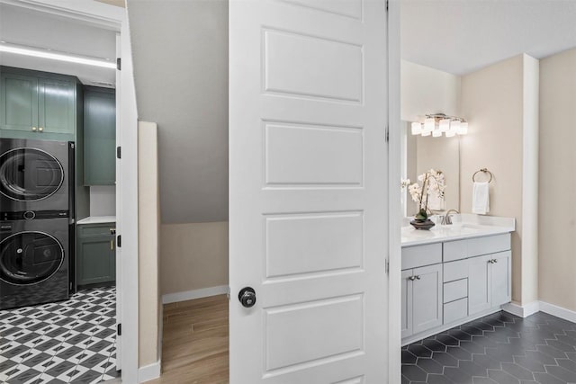 324 Pisa Ln, Georgetown, TX 78628 - bathroom featuring stacked washer and clothes dryer, baseboards, and vanity