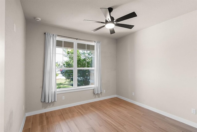 324 Pisa Ln, Georgetown, TX 78628 - unfurnished room with light wood-style flooring, a ceiling fan, a smoke detector, and baseboards