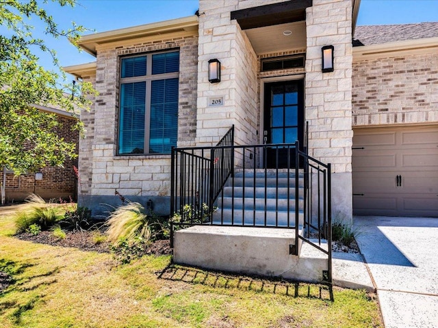 205 William Clayton Dr, Buda, TX 78610 - doorway to property featuring stone siding, a garage, and driveway