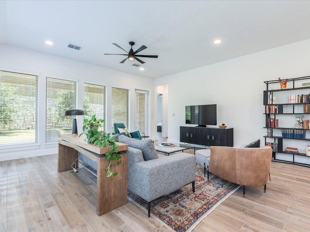 living room with a ceiling fan, light wood-style floors, recessed lighting, and baseboards