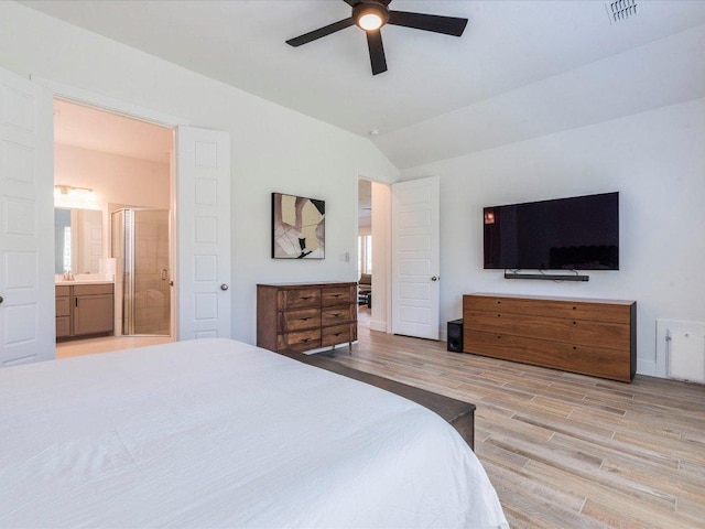 205 William Clayton Dr, Buda, TX 78610 - bedroom featuring lofted ceiling, light wood-style floors, ensuite bath, and a ceiling fan