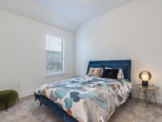 bedroom with carpet floors, baseboards, and vaulted ceiling