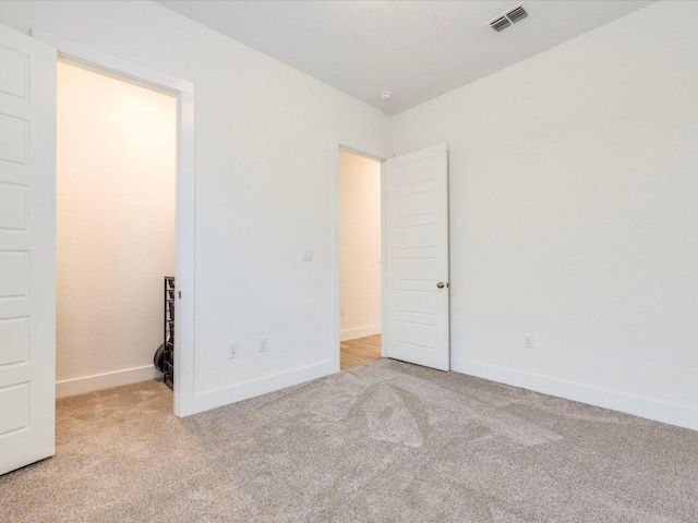 unfurnished bedroom with carpet and baseboards