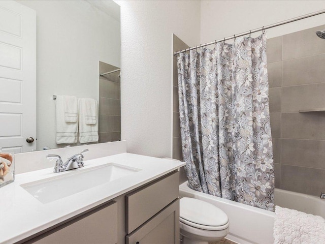 full bathroom featuring shower / bath combo with shower curtain, toilet, and vanity