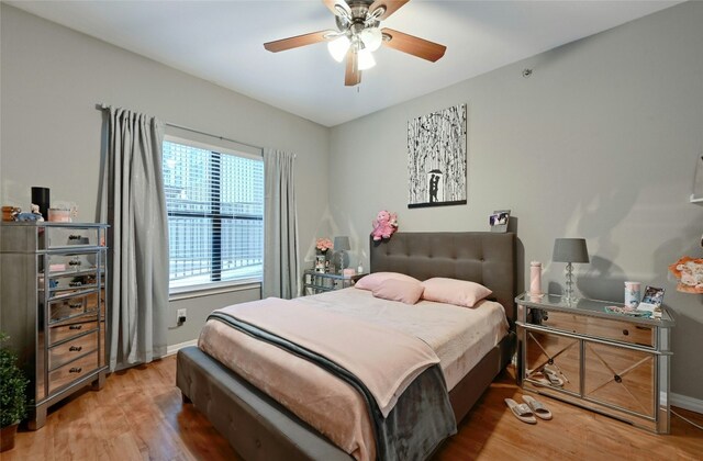 2502 Leon St Unit 213, Austin, TX 78705 - bedroom featuring wood finished floors, baseboards, and a ceiling fan