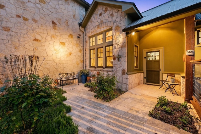 12316 Triple Creek Dr, Dripping Springs, TX 78620 - property entrance featuring stone siding and metal roof